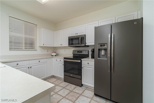 8461 Southbridge Dr Unit 4, Estero, FL 33967 - kitchen with appliances with stainless steel finishes, white cabinets, and light countertops