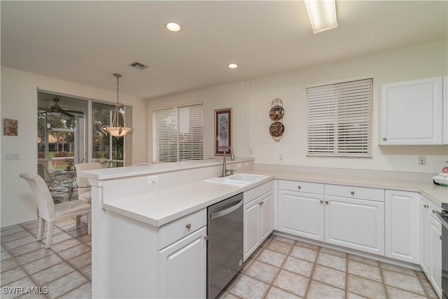 kitchen with kitchen peninsula, dishwasher, sink, decorative light fixtures, and white cabinetry