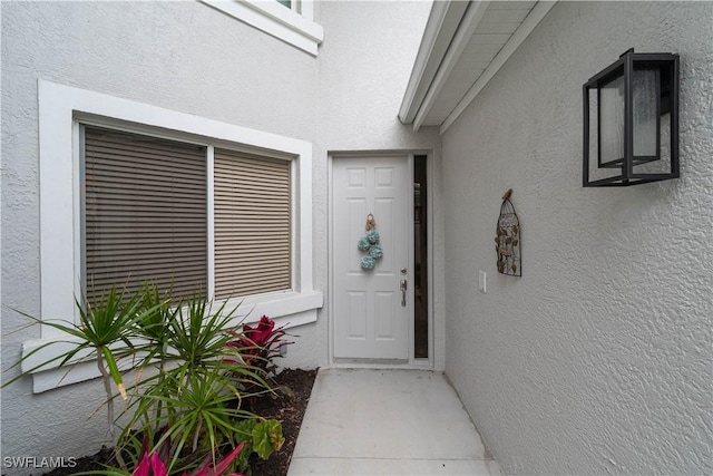 8461 Southbridge Dr Unit 4, Estero, FL 33967 - view of exterior entry featuring stucco siding