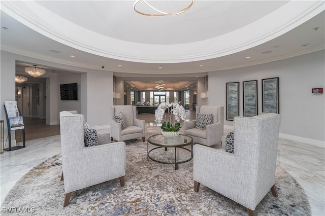 living room featuring a raised ceiling, an inviting chandelier, and crown molding