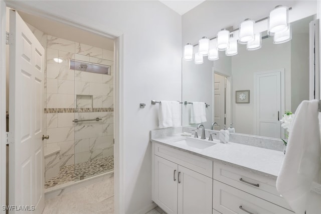 bathroom with vanity and tiled shower