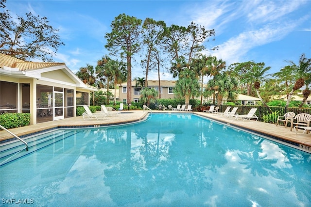 view of pool featuring a sunroom