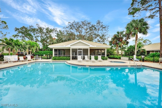 view of pool with a hot tub