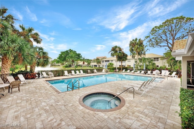 view of swimming pool with a patio area and a community hot tub