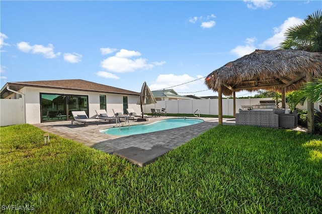 view of pool with a lawn, a patio area, a gazebo, and an outdoor living space