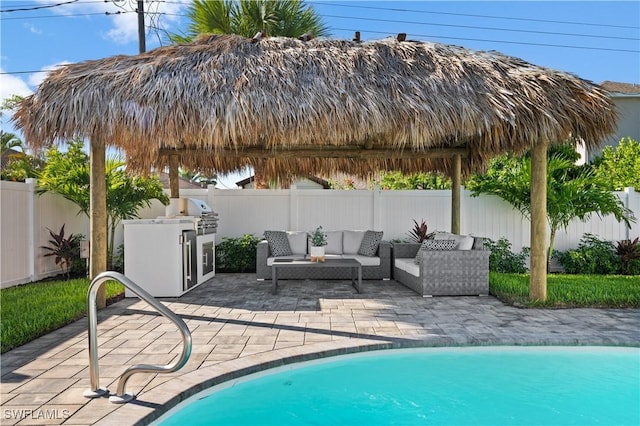 538 106th Ave N, Naples, FL 34108 - view of swimming pool with an outdoor kitchen, a fenced backyard, a patio, an outdoor living space, and a grill