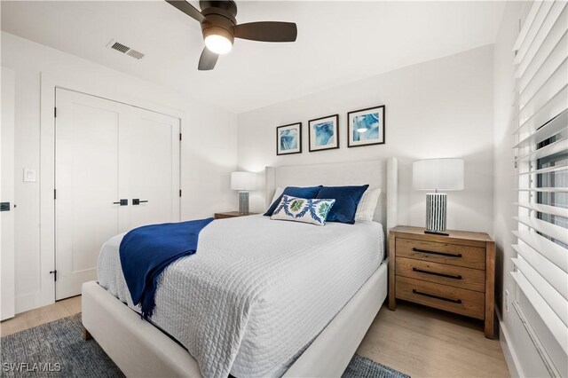 538 106th Ave N, Naples, FL 34108 - bedroom with wood finished floors, a closet, and ceiling fan