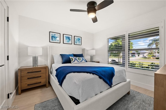 bedroom featuring light hardwood / wood-style floors and ceiling fan