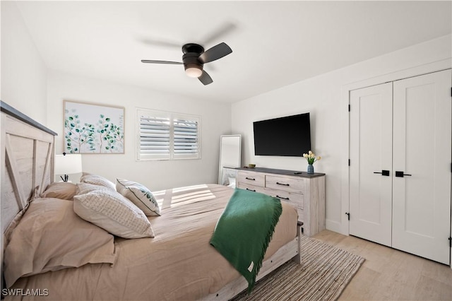 bedroom with a closet, ceiling fan, and light hardwood / wood-style flooring