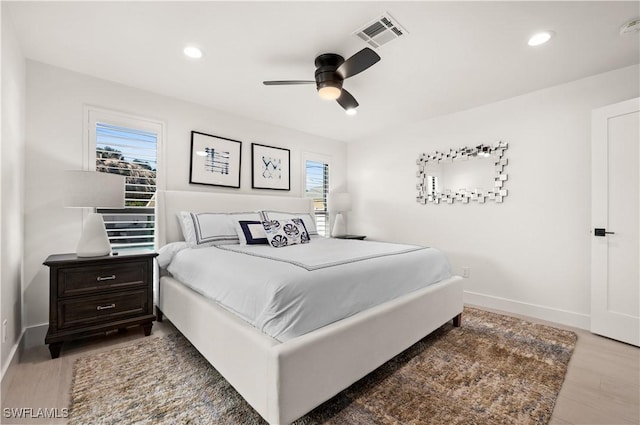 bedroom with ceiling fan and hardwood / wood-style flooring