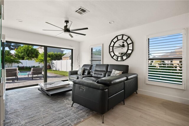 living room featuring hardwood / wood-style flooring and ceiling fan