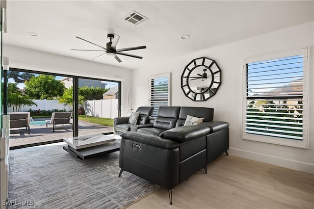 538 106th Ave N, Naples, FL 34108 - living room featuring ceiling fan, baseboards, and wood finished floors