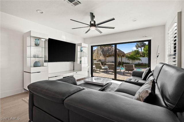 living room with light hardwood / wood-style floors and ceiling fan