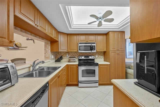 kitchen featuring light tile patterned flooring, appliances with stainless steel finishes, tasteful backsplash, sink, and a raised ceiling