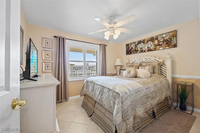 tiled bedroom featuring ceiling fan