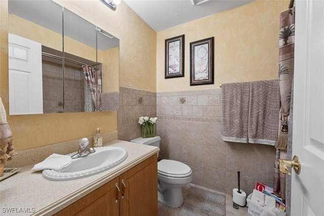 bathroom with tile walls, vanity, tile patterned floors, toilet, and walk in shower