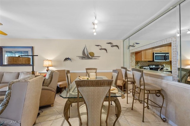 dining space featuring light tile patterned floors