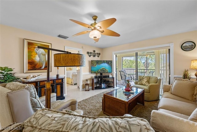 living room with light tile patterned flooring and ceiling fan