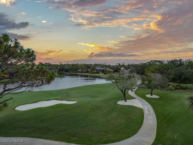 surrounding community featuring a water view and a yard