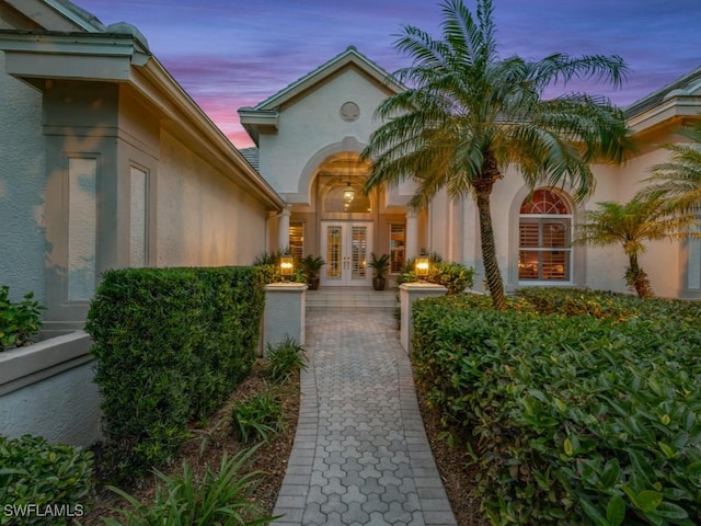 view of exterior entry at dusk