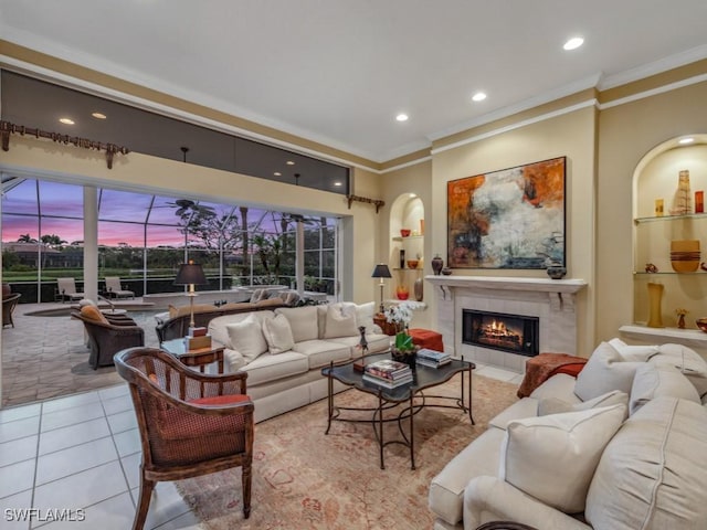 living room featuring crown molding, light tile patterned floors, built in features, and a fireplace