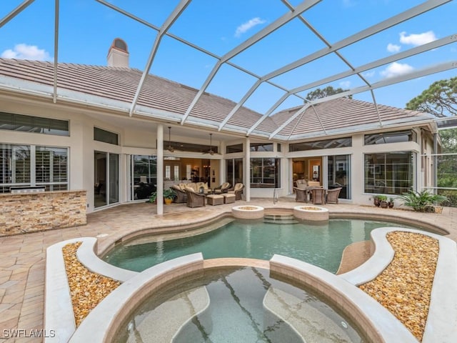 view of swimming pool with an in ground hot tub, outdoor lounge area, a patio area, and a lanai