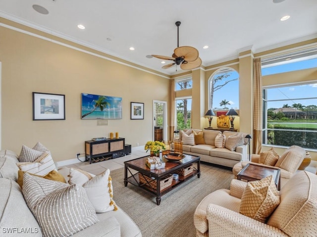 living room with crown molding, a healthy amount of sunlight, light tile patterned flooring, and ceiling fan