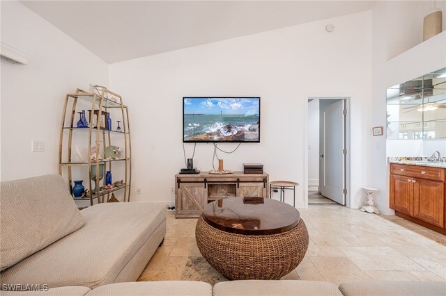 living room featuring sink and high vaulted ceiling