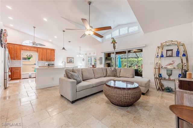 living room featuring sink, high vaulted ceiling, and ceiling fan