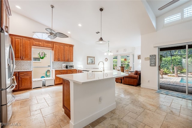 kitchen with high vaulted ceiling, sink, backsplash, and stainless steel fridge with ice dispenser