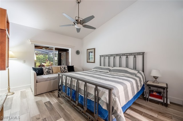 bedroom featuring hardwood / wood-style flooring, vaulted ceiling, and ceiling fan