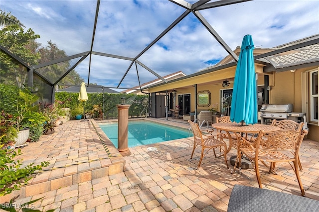 view of swimming pool featuring ceiling fan, a patio area, a lanai, and area for grilling