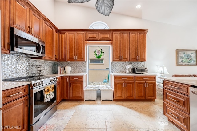 kitchen with decorative backsplash, stainless steel appliances, and vaulted ceiling