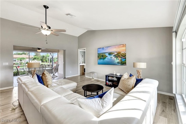 living room with light hardwood / wood-style flooring, vaulted ceiling, and ceiling fan