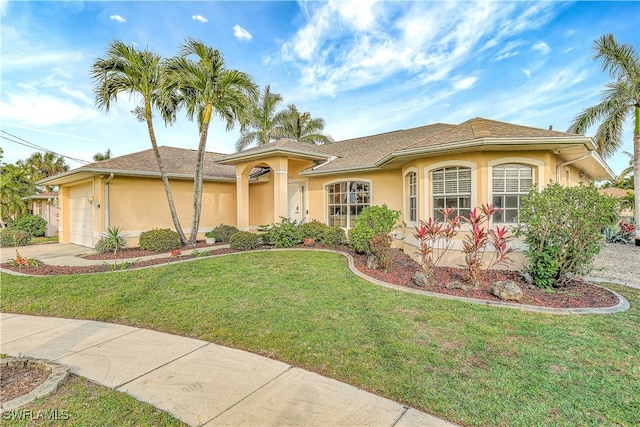 view of front of house featuring a front yard and a garage