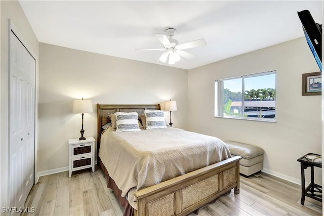 bedroom featuring ceiling fan, a closet, and light hardwood / wood-style flooring