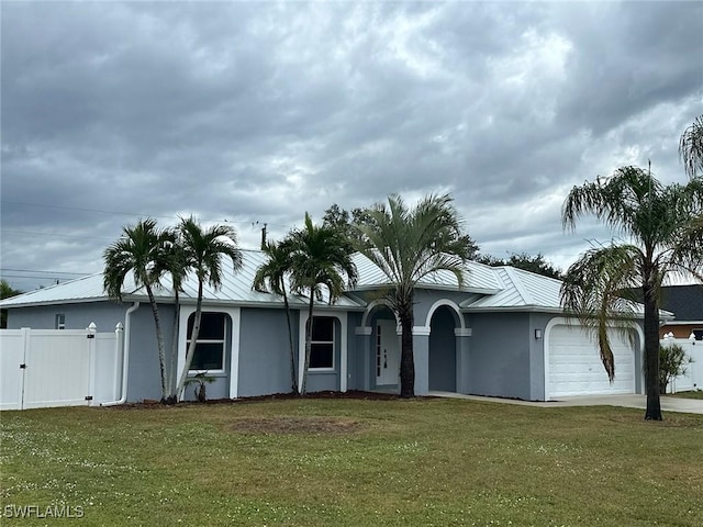 ranch-style house featuring a garage and a front yard