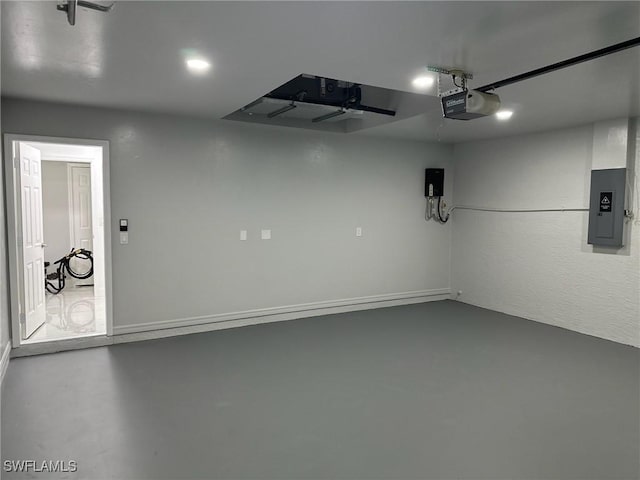 garage featuring electric panel and a garage door opener