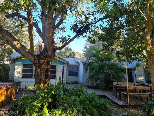 exterior space featuring a deck and stone siding