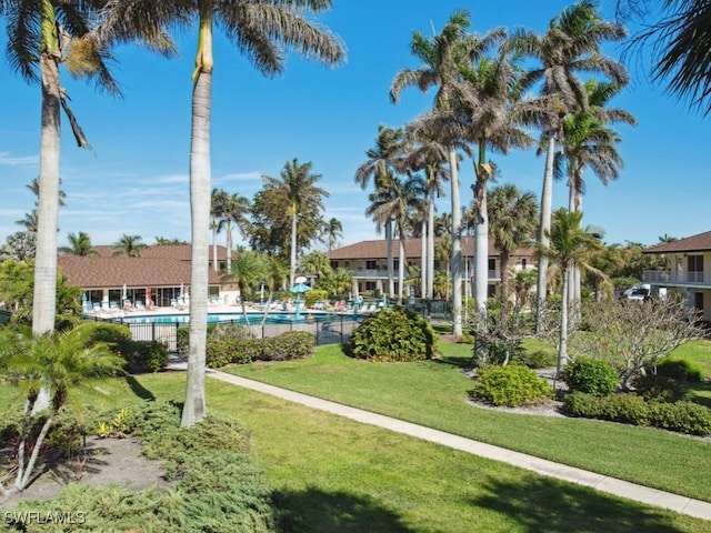 surrounding community featuring a pool and a lawn