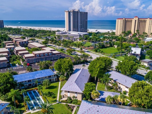 birds eye view of property with a water view and a view of the beach