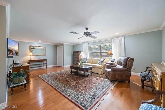 living room with ceiling fan, ornamental molding, and hardwood / wood-style floors