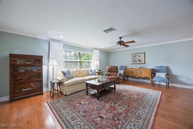 living room with ceiling fan, ornamental molding, and hardwood / wood-style floors