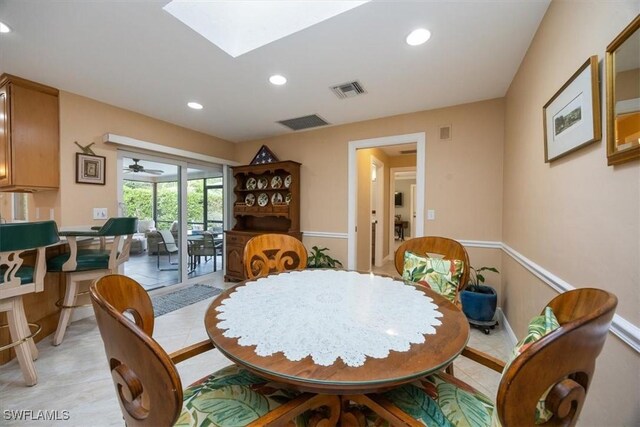 dining room with a skylight