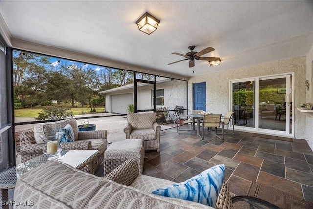 view of patio / terrace featuring an outdoor living space, a garage, and ceiling fan