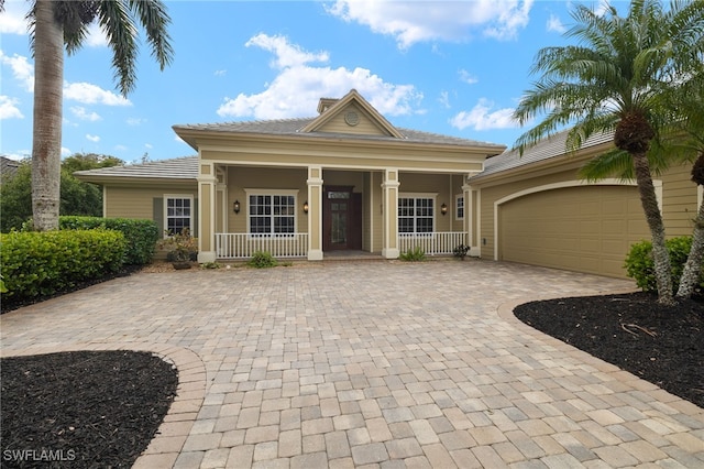 view of front of property with covered porch and a garage