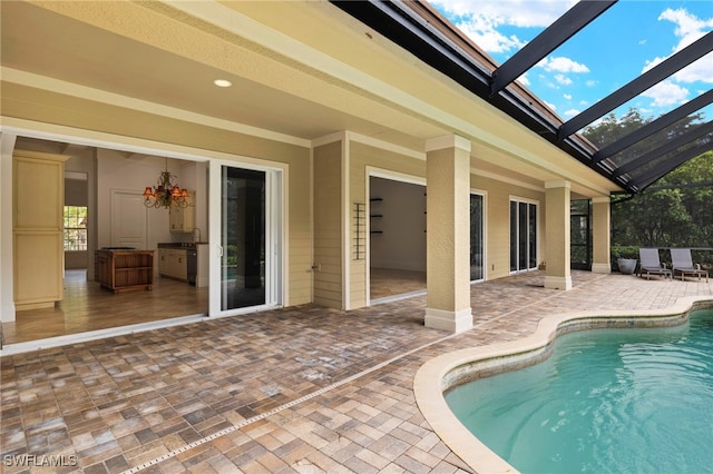 view of swimming pool with a lanai and a patio