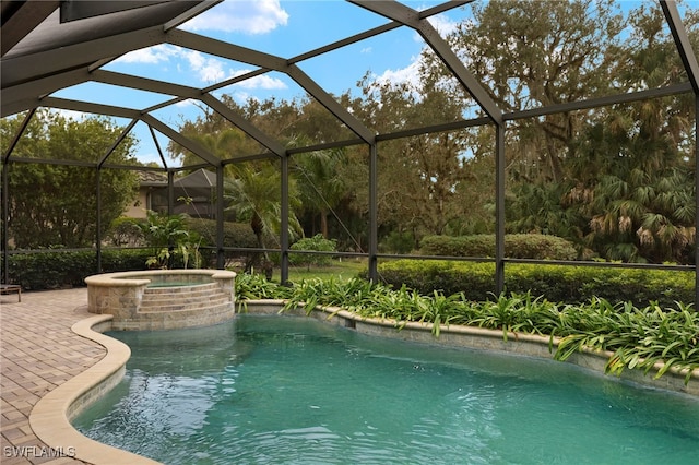 view of swimming pool with a patio, glass enclosure, and an in ground hot tub