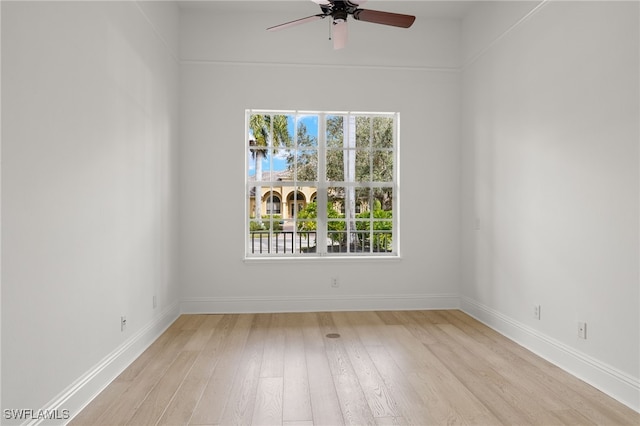 spare room with light hardwood / wood-style floors, ceiling fan, and a healthy amount of sunlight