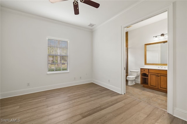 unfurnished bedroom featuring ceiling fan, sink, light wood-type flooring, connected bathroom, and ornamental molding